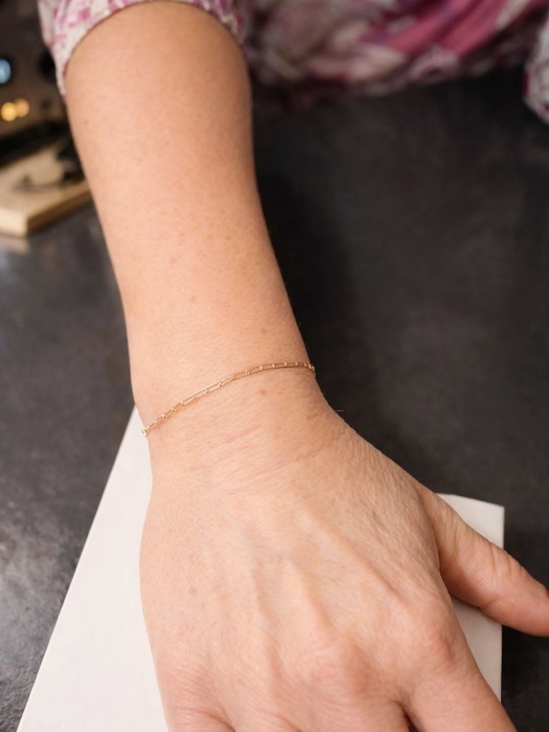 Delicate gold permanent bracelet on wrist